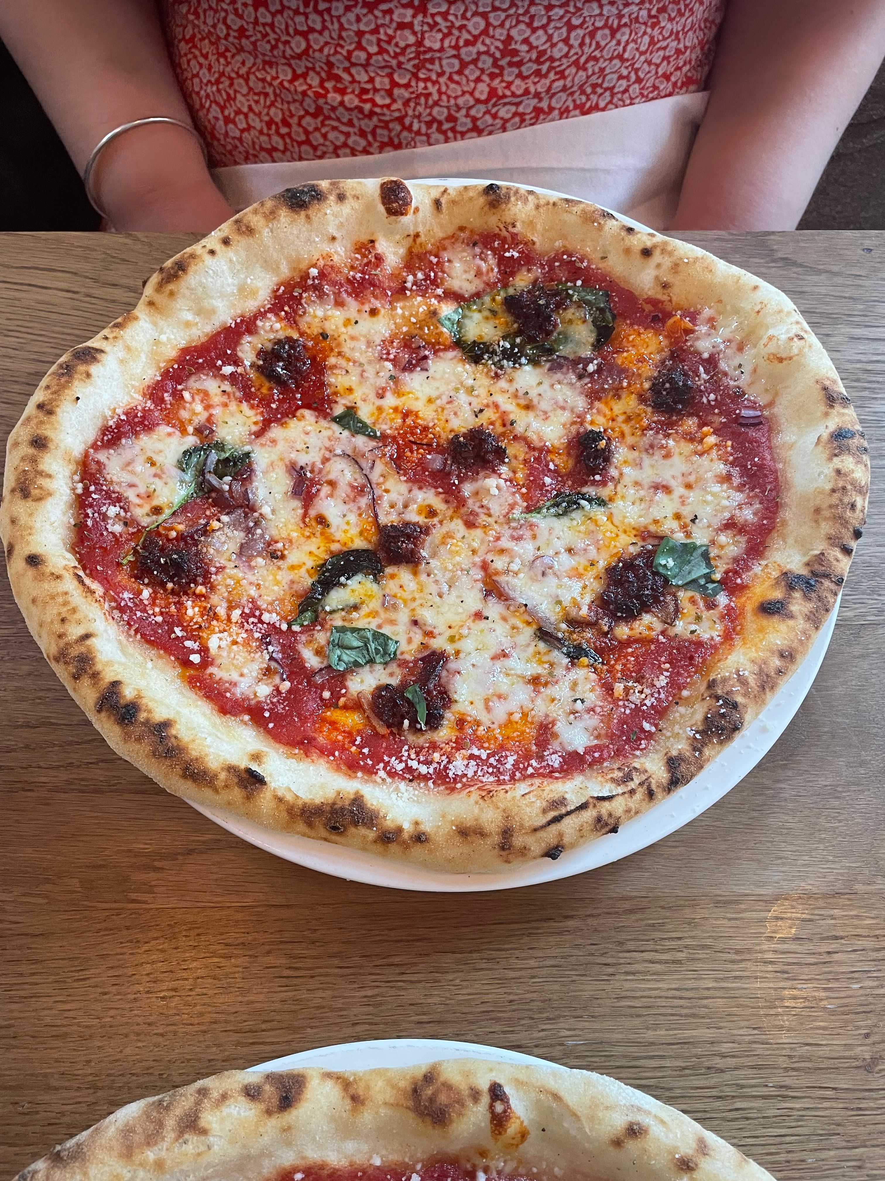 A fully gluten-free pizza topped with ‘nduja and red onion